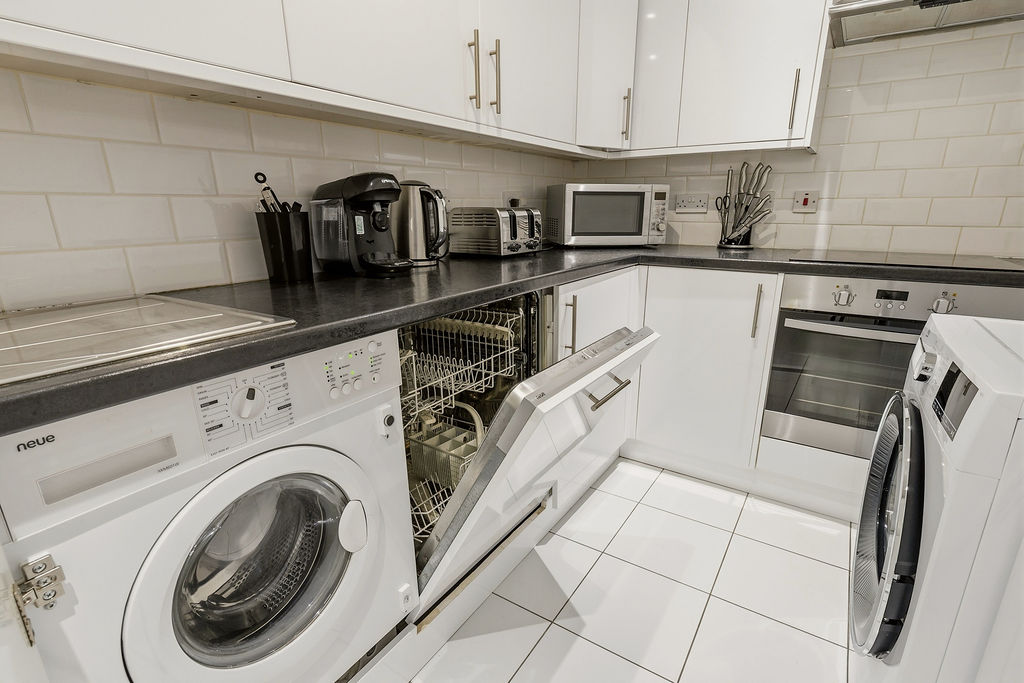 Bright white kitchen and utility area